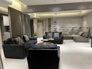 a large living room with couches and a table at Jumbo Heavens 5 Bedroom Scenic Luxury Pool Villa in Mahabaleshwar