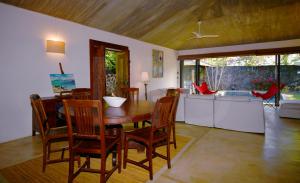 a living room with a wooden table and chairs at Elegant Villa with pool and privacy Blue Bay in Blue Bay