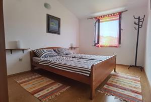 Postel nebo postele na pokoji v ubytování Apartmani Ruk