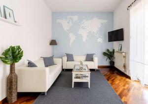 a living room with a white couch and a table at Romely House St Peter Apartment in Rome