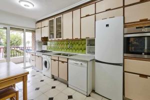 a kitchen with a refrigerator and a dishwasher at Apartamento Marina de Pasaia in Pasai San Pedro