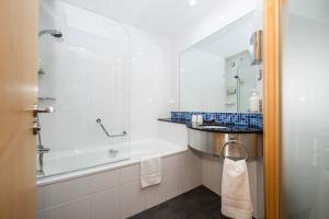 a bathroom with a tub and a sink and a shower at Holiday Inn Express Barcelona City 22@, an IHG Hotel in Barcelona