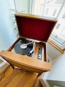 a record player in a wooden box with a vinyl record at Charming 2-Bedroom Apartment Located in Ayr in Ayr