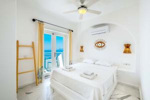 a white bedroom with a bed and a window at Payam Hotel in Kas