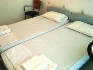 Postel nebo postele na pokoji v ubytování Dimitra Hotel