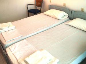 Postel nebo postele na pokoji v ubytování Dimitra Hotel