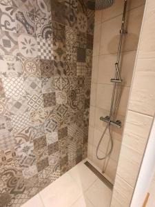 La salle de bains est pourvue d'une douche et d'un mur carrelé. dans l'établissement appartement Shangrila, à Chamonix-Mont-Blanc