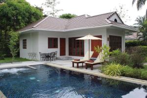 a house with a swimming pool in front of a house at Alisea Pool Villa Aonang in Ao Nang Beach