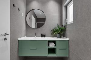 a bathroom with a green sink and a mirror at Apartments No 18 in Tučepi +48 photos