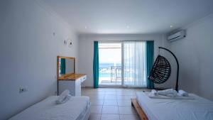 a bedroom with two beds and a view of the ocean at Sole'n Blu in Kaş