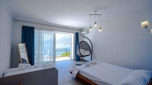 a bedroom with a bed and a large window at Sole'n Blu in Kaş