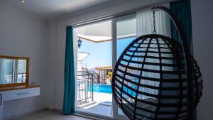 a room with a large window with a hammock at Sole'n Blu in Kaş