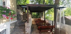 patio z drewnianymi stołami, ławkami i kwiatami w obiekcie Na Skalce w mieście Vranov nad Dyjí