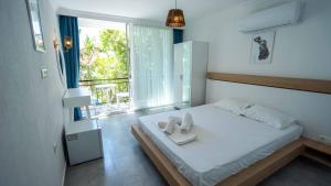 a bedroom with a bed with two towels on it at Sole'n Blu in Kaş