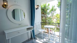 a bathroom with a mirror and a balcony at Sole'n Blu in Kaş