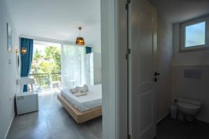 a small bedroom with a bed and a window at Sole'n Blu in Kaş
