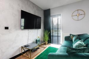 Televízia a/alebo spoločenská miestnosť v ubytovaní Victoria Apartment