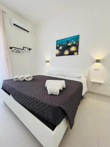 a bedroom with a large bed in a white room at Pirro’s rooms in Peschici