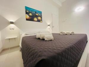 a bedroom with a large bed with towels on it at Pirro’s rooms in Peschici