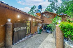 a building with a gate and a car parked in a driveway at Royal Mount Ella in Ella