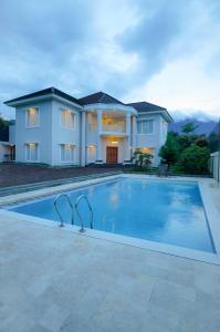a large swimming pool in front of a house at Villa Andalus 1&2 in Puncak