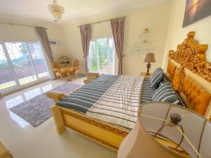 a bedroom with a large bed in a room at Villa Andalus 1&2 in Puncak +50 photos