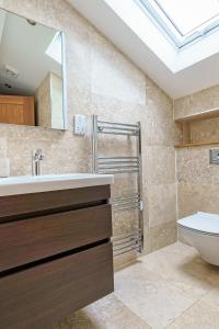 a bathroom with a sink and a toilet at 7 Pen y Bont in Abersoch