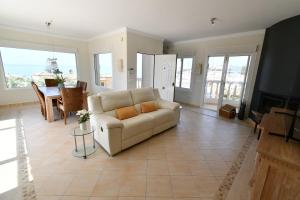 a living room with a couch and a table at Villa with separate apartment in Mijas Costa