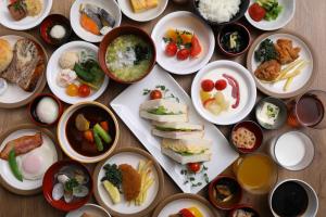 a bunch of plates of food on a table at Dormy Inn Express Fujisan Gotemba in Gotemba