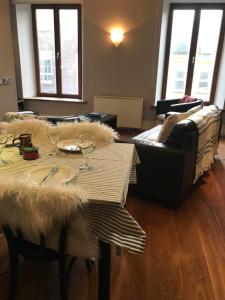 a living room with a table and a couch at Centre of Dingle Town - Luxury Holiday Apartment in Dingle