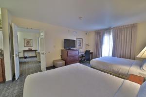 a hotel room with two beds and a television at Staybridge Suites Lansing-Okemos, an IHG Hotel in Okemos