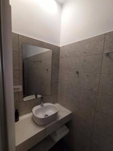 a bathroom with a sink and a mirror at Katerina Traditional Rooms in Chania Town