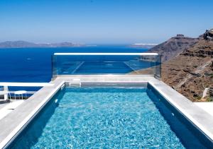 a swimming pool with a view of the ocean at Hotel Thireas in Fira