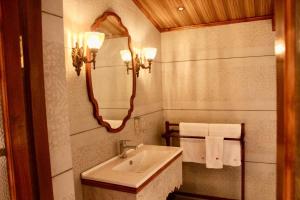 a bathroom with a sink and a mirror and towels at Hotel Mount View Heritage in Panchgani +40 photos