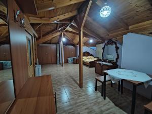 a living room with a table and a mirror at Lovely 1 - bedroom loft with free parking in Gjirokastër