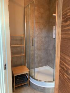 a shower with a glass door in a bathroom at Centre of Dingle Town - Luxury Holiday Apartment in Dingle