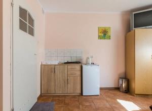 a kitchen with a white refrigerator in a room at Pokoje Wilkasy in Wilkasy