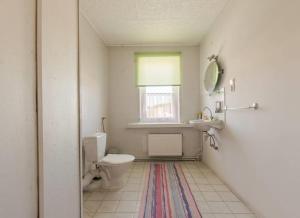 a bathroom with a toilet and a sink and a window at Pokoje Wilkasy in Wilkasy +19 photos