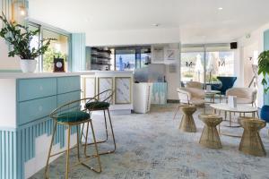 a store with chairs and tables in a room at Best Western Hotel Mediterranee Menton in Menton