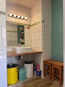 a kitchen with a sink and a counter with buckets at Joli appartement F2 centre ville de Corte in Corte