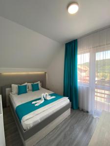 a bedroom with a bed with a person laying on it at Casa Alberto in Sovata