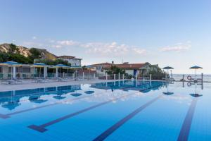 a swimming pool with a pool table and chairs at Hotel Brancamaria in Cala Gonone