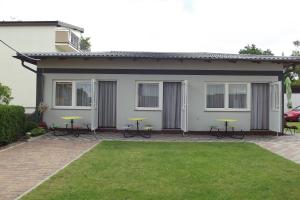 a house with picnic tables in front of it at Andrzejówka in Jastrzębia Góra