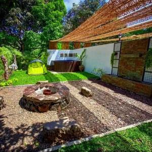 a backyard with a fire pit and a tent at Casa De Cortijo Family Room in Pagbilao