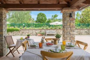 an outdoor table with chairs and a table set for a meal at White Tail Organic Farm in Orsara Bormida