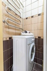 a washing machine with a cat on top of it at Small But Comfy Flat in The Old Town Center VIP in Klaipėda