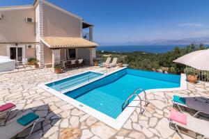 a villa with a swimming pool and a house at Villa Maria Kassiopi by Villa Plus in Kelliá