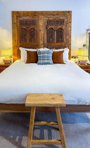 a bedroom with a large bed with a wooden headboard at Parador 44 in Cardiff