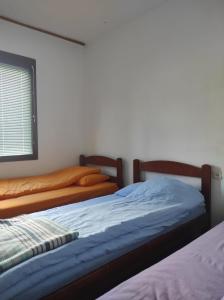 Säng eller sängar i ett rum på Apartmani Vila Šljukić