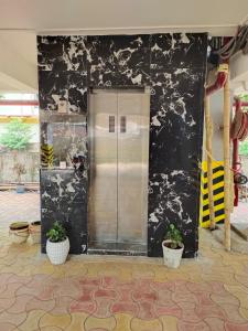 a elevator in a building with black and white wallpaper at JD Grand Inn in Guwahati